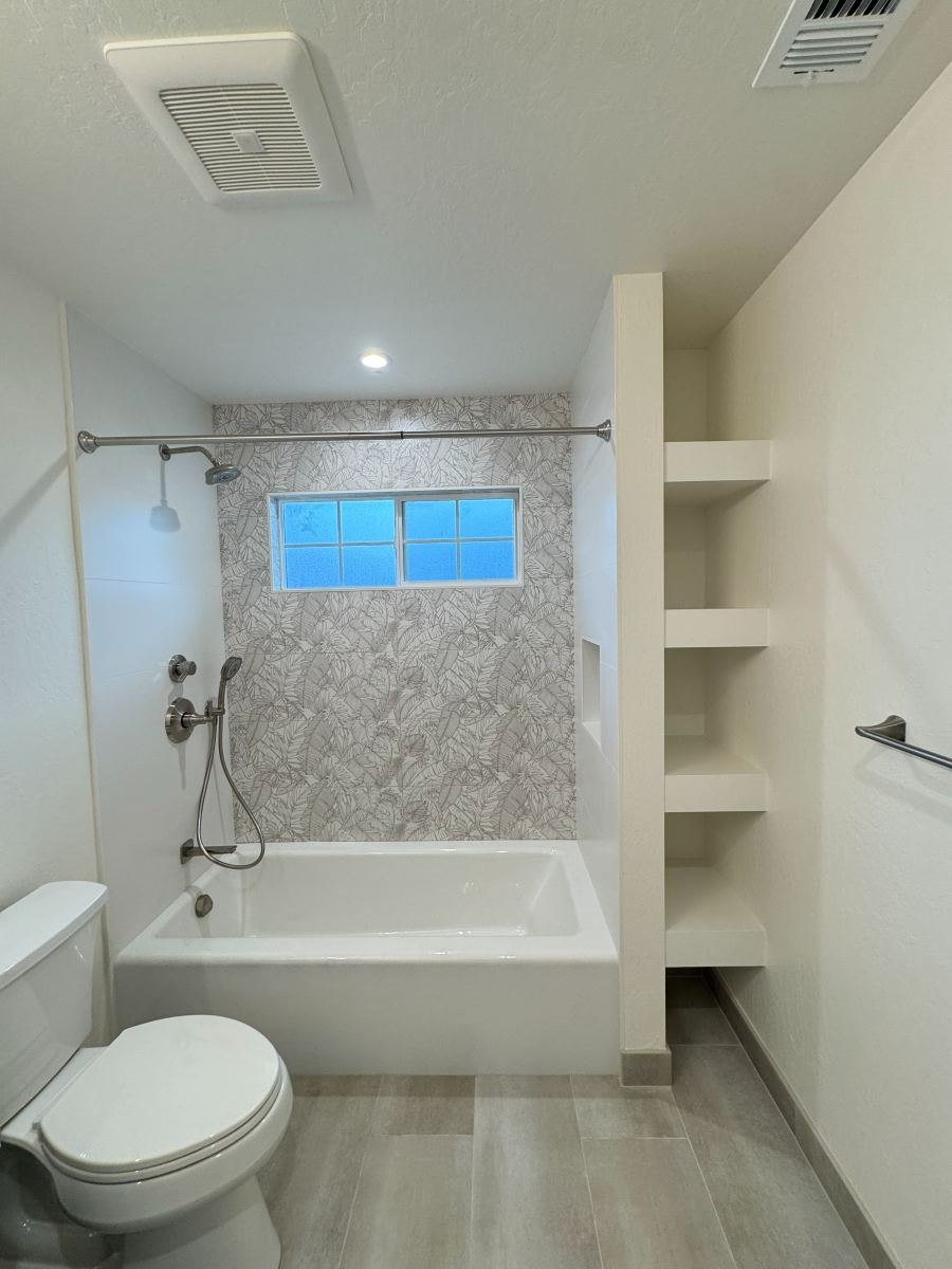 Tub and shower remodel with patterned tile and built-in shelves